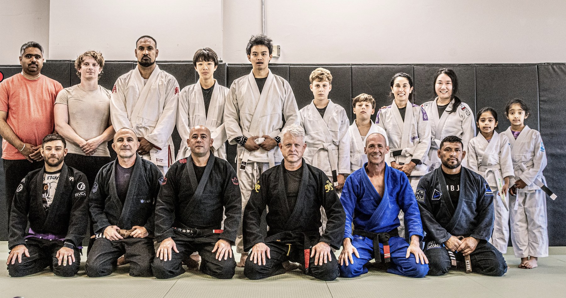 A group of students and instructors on the mat